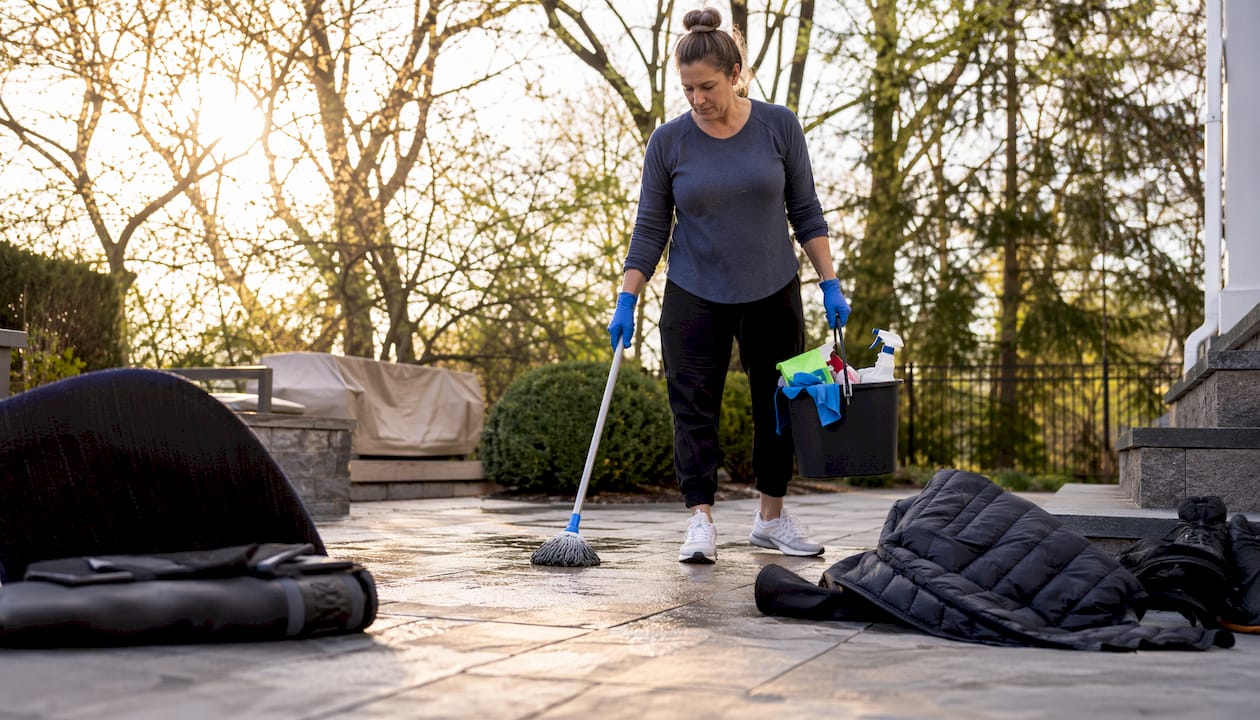 Woman mopping salt-stained foyer floor